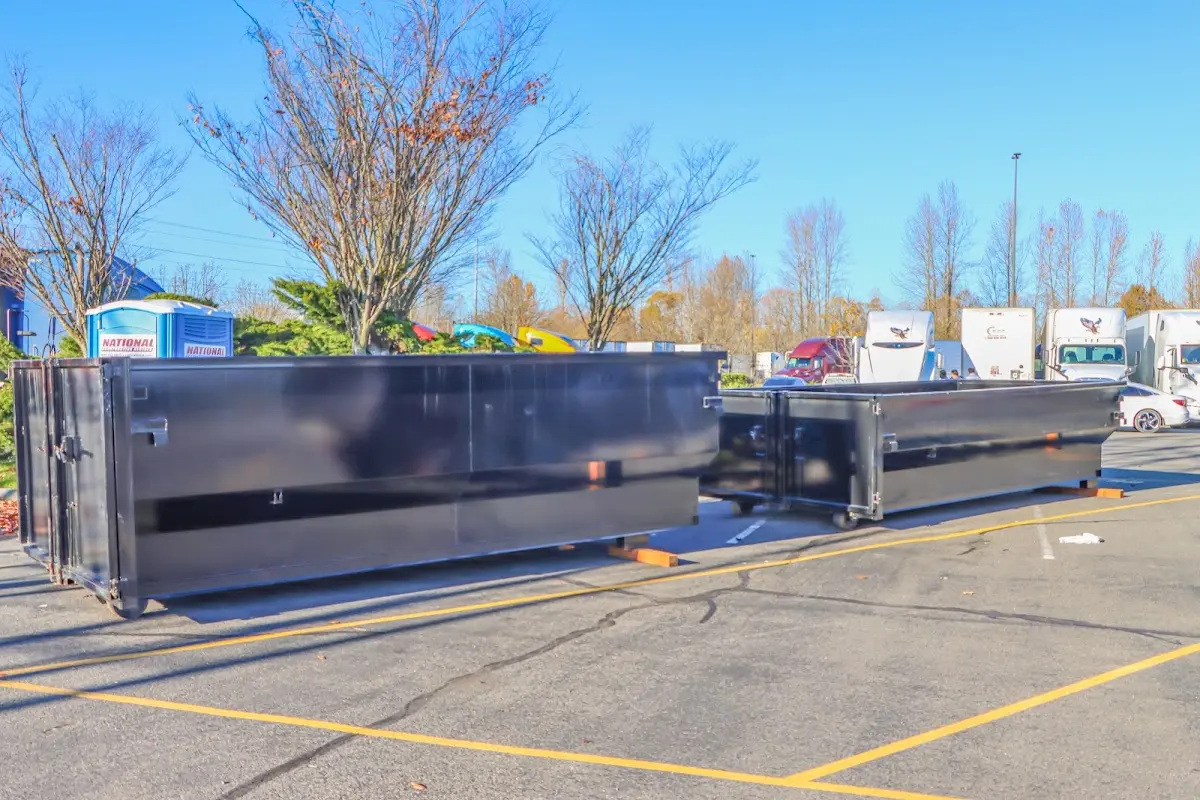 Professional dumpster rental service with roll-off container on residential driveway in Tell City